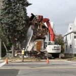 Image of crain tearing down a tax-foreclosed home in Adrian